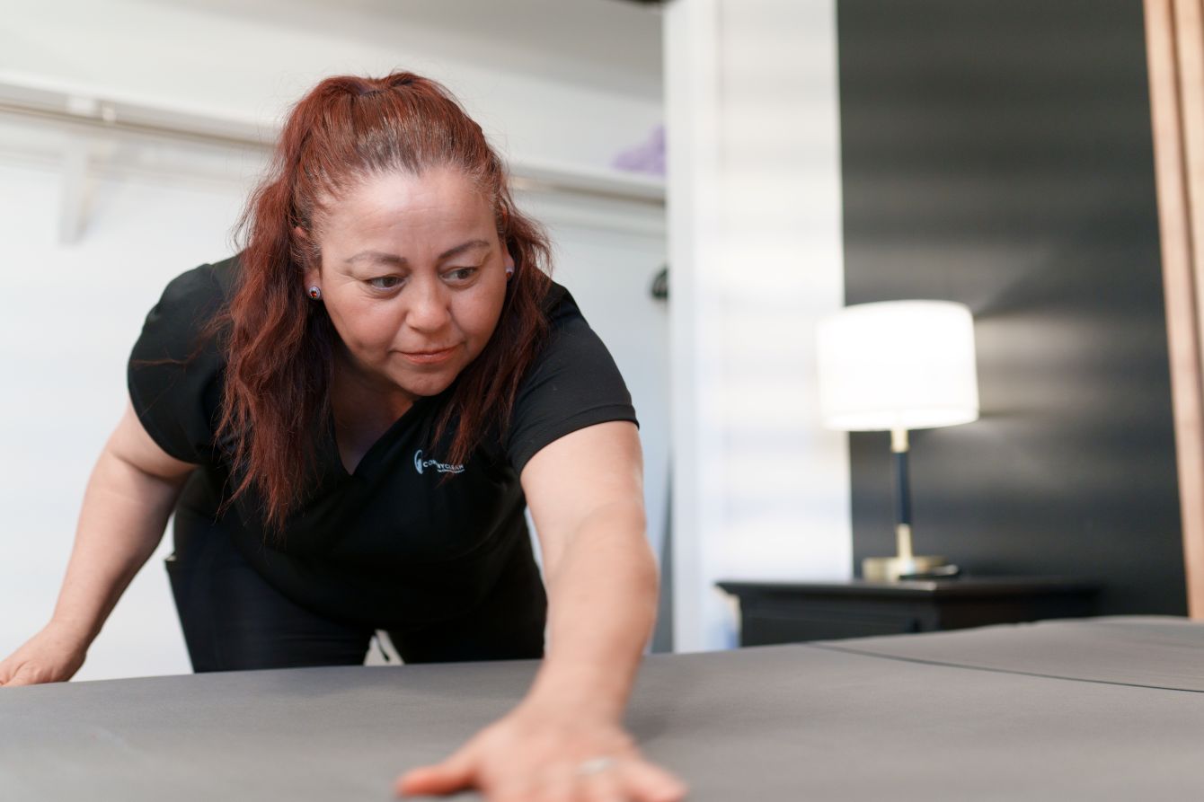 CompanyClean trained cleaner making a bed